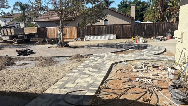 Stone paver patio installation in a San Diego outdoor living space